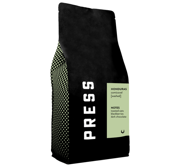 Side view of Tanzania comicovel coffee bag by Press Coffee. Featuring notes of toasted oats, blackberries, and dark chocolate. 