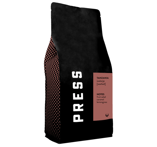 A side view of Tanzania iwalanje washed process coffee bag. Featuring notes of fruit salad, caramel, and lemongrass. 