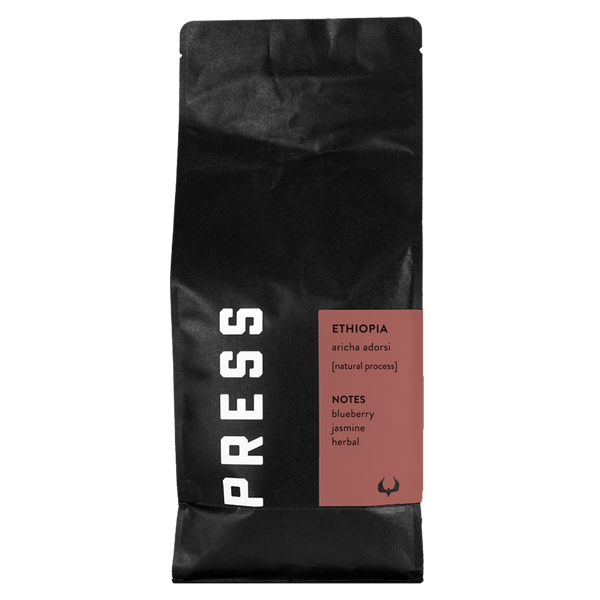 Black coffee bag with 'PRESS' branding and Ethiopia coffee details on a white background