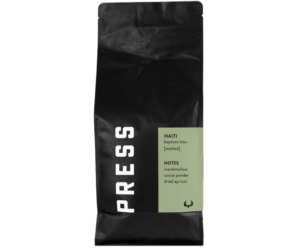 Haiti Baptiste Bleu washed process coffee by Press Coffee Roasters. Featuring notes of mashmallow, cocoa powder, and dried apricot. 