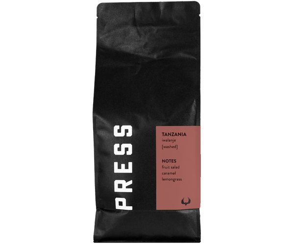 Forward facing view of Tanzania iwalanje coffee bag by Press Coffee Roasters. Featuring notes of fruit salad, caramel, and lemongrass.  