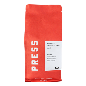 Red coffee bag with 'PRESS' branding and a white label on a white background