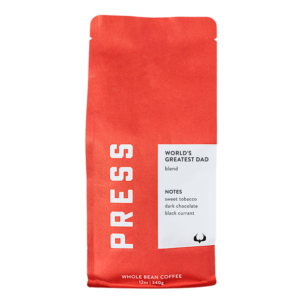 Red coffee bag with 'PRESS' branding and a white label on a white background