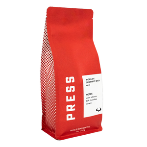 Red coffee bag with 'PRESS' branding and a label on a white background