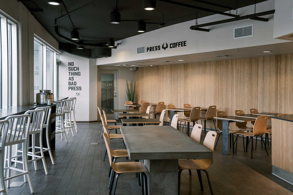 An interior photo of our Skywater cafe featuring sleek chairs and tables and wood-finished wall. 